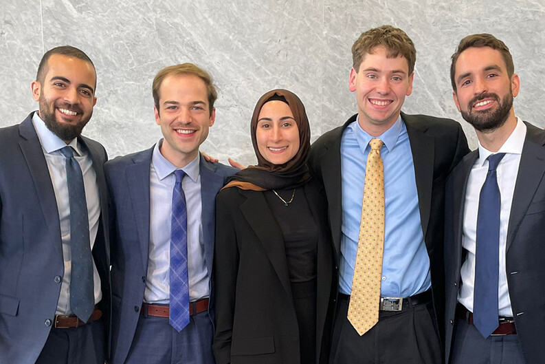 Five students Yale Law School’s 2023 Jessup International Law Moot Court CompFive students — Ali Hakim ’24, Thomas Poston ’24, Alaa Hachem ’24, Justin Cole ’23 and Matei Alexianu ’23 — smile and stand shoulder to shoulder before a gray marble-patterned wall.