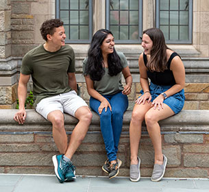 three students sharing a laugh outside the Law School