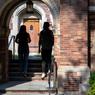 Silhouette of two students walking through YLS archway together