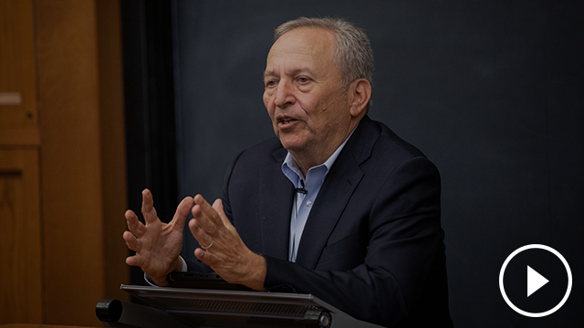 Larry Summers speaking at a lectern