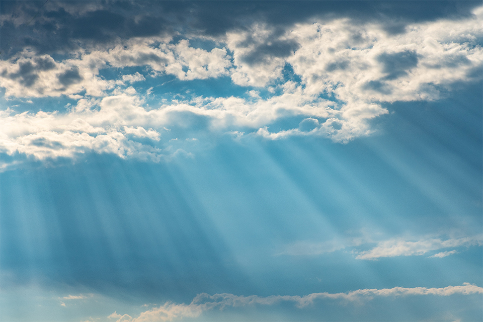 Clouds and sunbeams on a blue sky