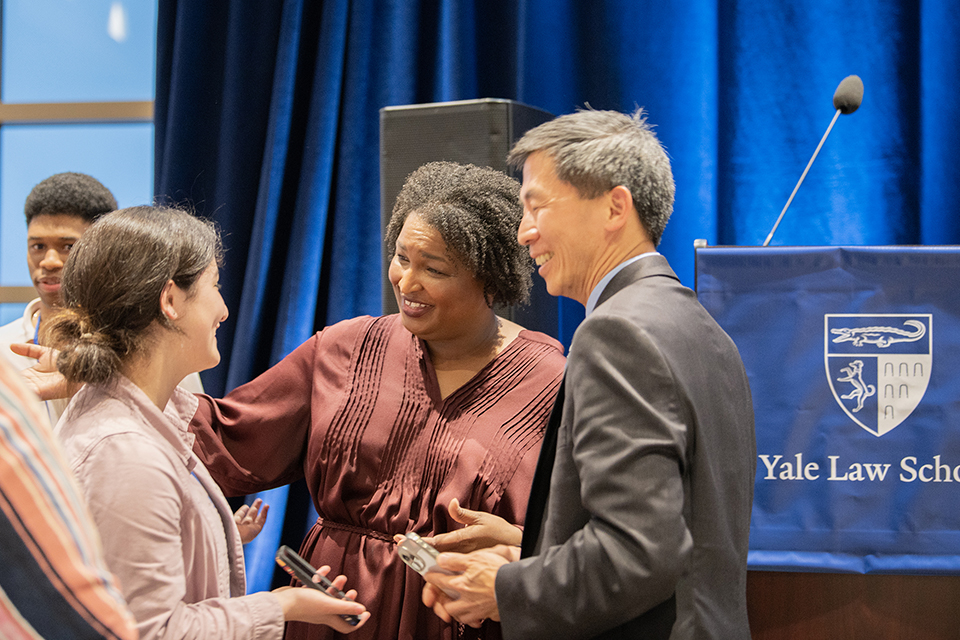Stacey Abrams and Goodwin Liu talk to a fellow alum at the Diversity Homecoming