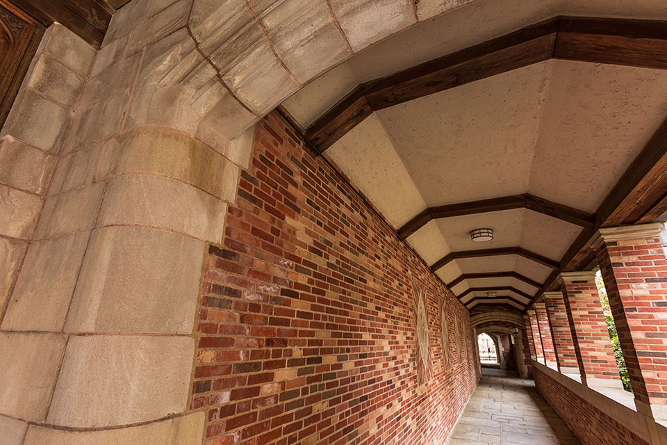 Sterling Law Building colonnade passageway with brick wall and stone and wood arches