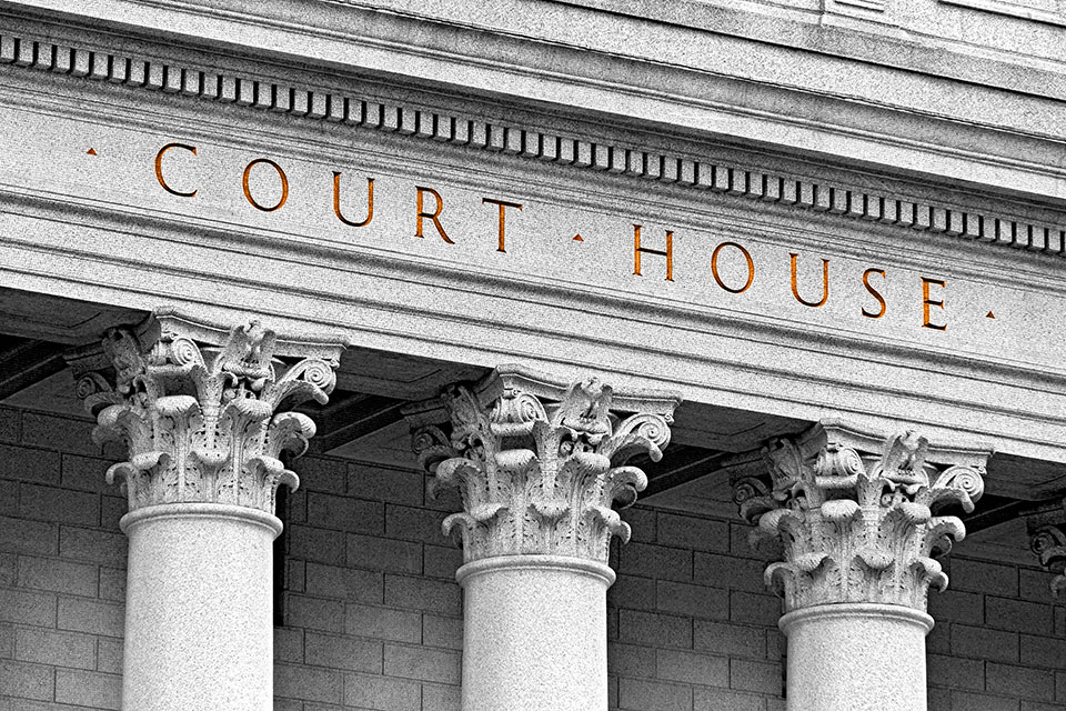 Architecture of a courthouse with the words "court house" carved in stone