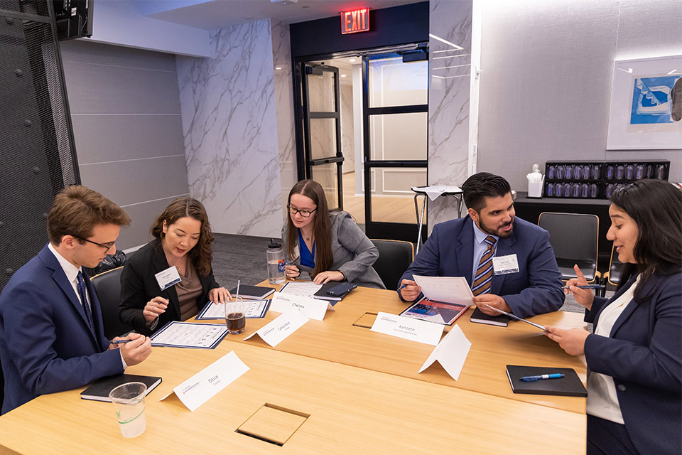 group of five launchpad scholars working at a table