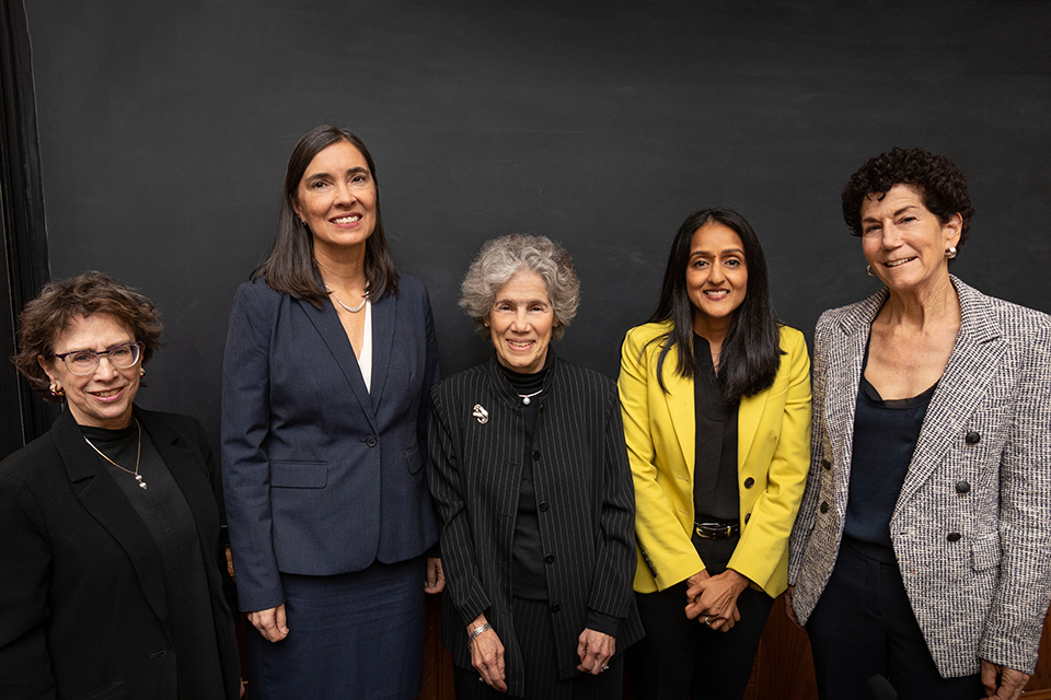 Standing in front of a chalkboard, from left: Sheryl Gordon McCloud, Associate Justice, Washington Supreme Court; Anita Earls, Associate Justice, North Carolina Supreme Court; Judith Resnik, Arthur Liman Professor of Law, Yale Law School; Vanita Gupta, Associate Attorney General of the United States; and Lisa Foster, former Director, U.S. Department of Justice, Access to Justice Office