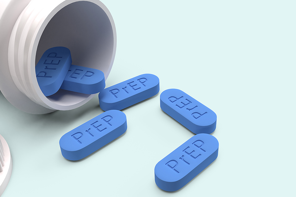 blue PrEP pills and a prescription bottle