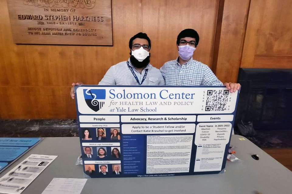 Hirsh Shekhar and Kunal Pontisat with a poster for the Solomon Center