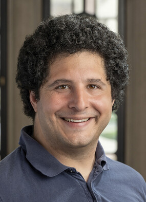 Daniel Greco smiles to the camera.