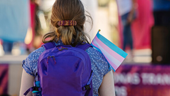 girl holding transgender awareness flag