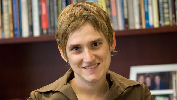 Closeup of Amy Kapczynski in her office with a bookshelf in the background