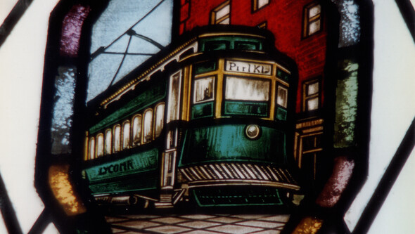stained glass window detail of a trolley