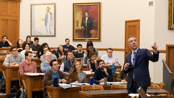 Professor John Witt teaching students in a tiered classroom