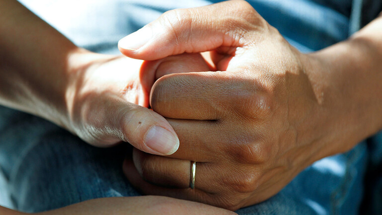 palliative care holding hands