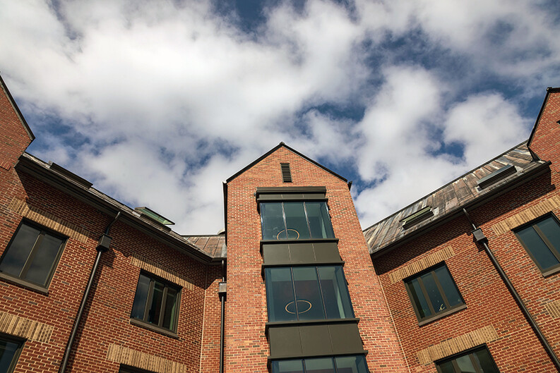 The upper floors of Baker Hall against a cloudy blue sky
