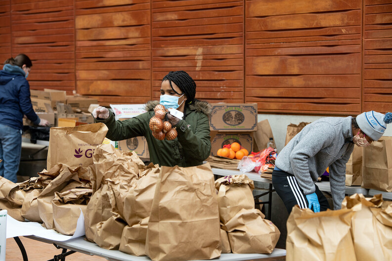 People packing bags of a food for a food distribution program
