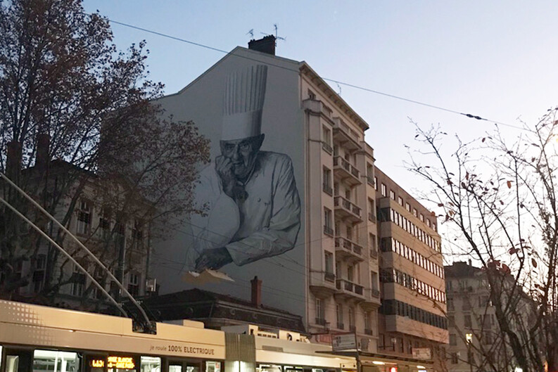 A mural of chef Paul Bocuse on a building in Lyon, France