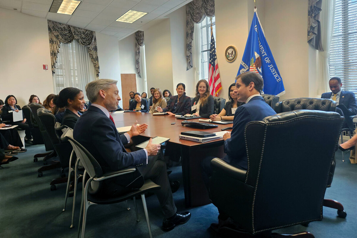 students around a conference table at the Department of Justice