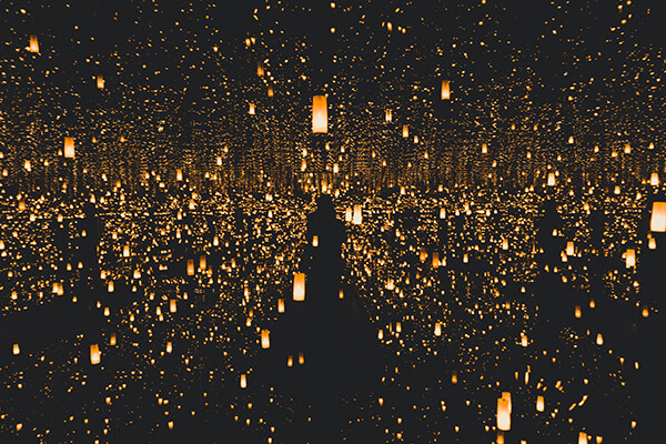 illuminated paper lanterns in a dark sky