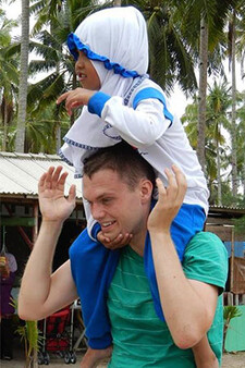 Paul Rink carries a small child on his shoulders