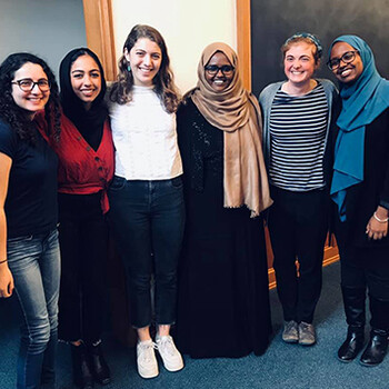 Dr. Deqo Mohamed stands with a group of female students