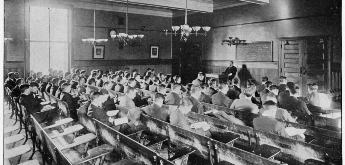 Students sit facing their professor in a Hendrie Hall classroom.