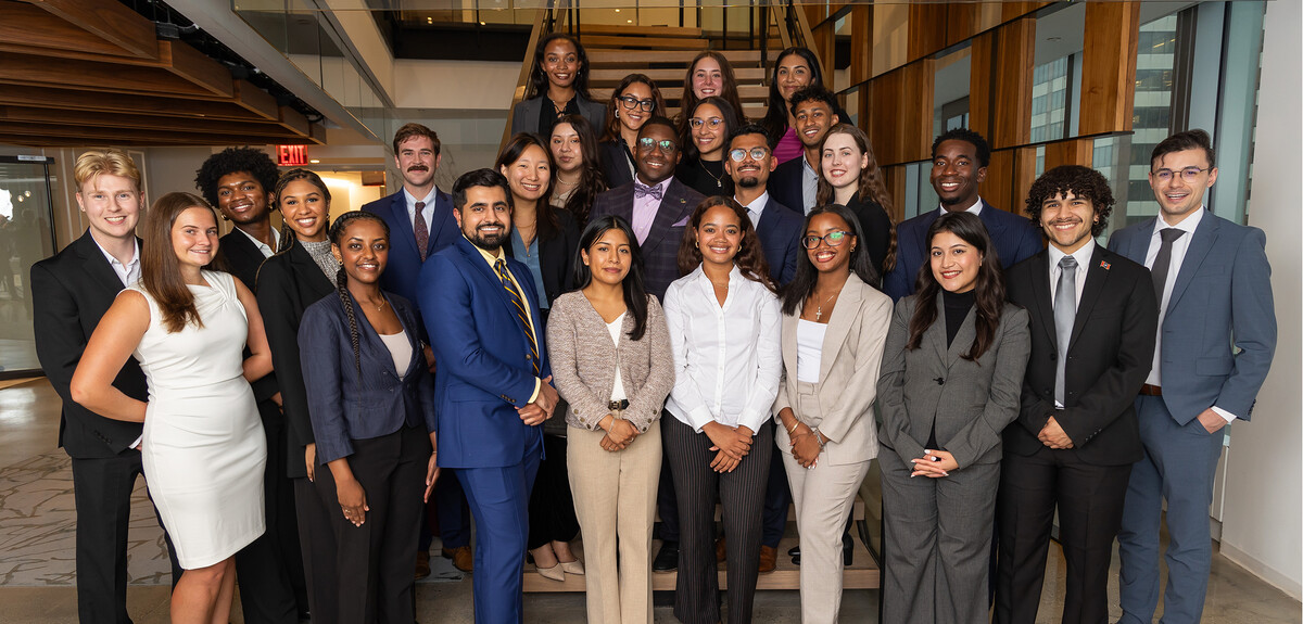 a group of people in business attire standing in a corporate setting