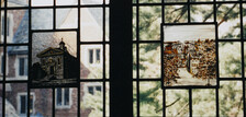 Two scenes in a stained glass window in the Sterling Law Building.