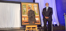 Associate Dean Mike Thompson with portrait at regional event