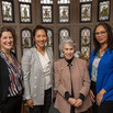 Dr. Brie Williams, Dr. Emily Wang, Professor Judith Resnik, and Professor Andrea Armstrong standing in front of a stained-glass window