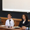Panelists seated in front of a chalkboard