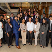 group of 25 new Launchpad Scholars standing in the lobby of a law firm