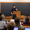 Professor Taisu Zhang teaching in a classroom in front of a blackboard and a group of seated students