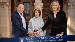 Gene and Carol Ludwig and Dean Gerken cut the ribbon to dedicate Ludwig Hall
