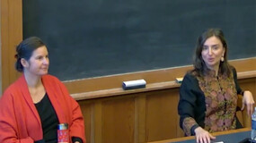 Hope Metcalf (left) and Roya Hakakian seated before a chalkboard