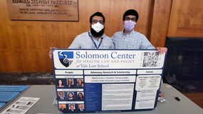 Hirsh Shekhar and Kunal Pontisat with a poster for the Solomon Center