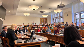 classroom with panelists and audience seated