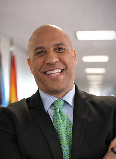 Corey Booker smiling in an office hallway