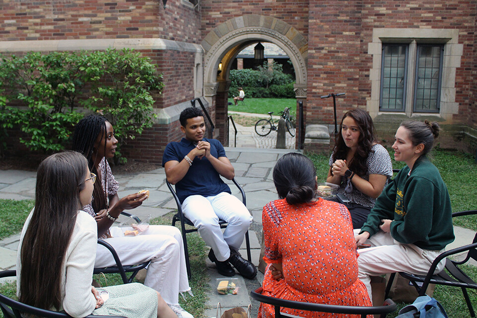 student-conversation-in-front-of-archway.jpg